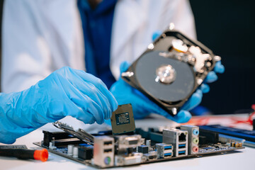 Obraz premium Technician repairing inside of hard disk drive by screwdriver. the concept of data, hardware, technician