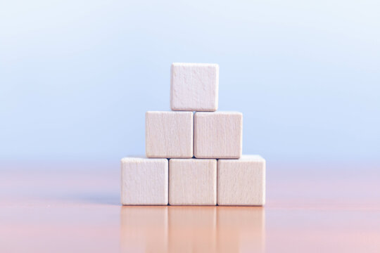 Wooden blocks on wooden table, white banner background with space for text, empty template, business and education concept.