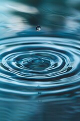 Serene Water Drop Rippling on Blue Surface