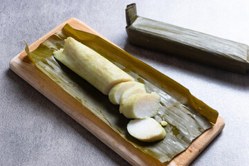 Lontong, rice rolled in banana leaves and boiled. Indonesian traditional food. Perfect for recipe, article, catalogue, commercial, or any cooking content.