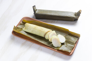 Lontong, rice rolled in banana leaves and boiled. Indonesian traditional food. Perfect for recipe, article, catalogue, commercial, or any cooking content.