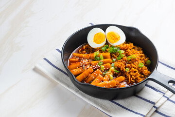 Korean instant noodles with Korean rice cake and fish cake and boiled egg - Rabokki - Korean food style. Perfect for recipe, article, catalogue, commercial, or any cooking content.