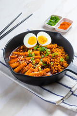 Korean instant noodles with Korean rice cake and fish cake and boiled egg - Rabokki - Korean food style. Perfect for recipe, article, catalogue, commercial, or any cooking content.