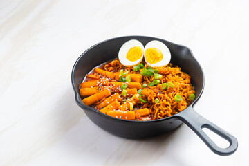 Korean instant noodles with Korean rice cake and fish cake and boiled egg - Rabokki - Korean food style. Perfect for recipe, article, catalogue, commercial, or any cooking content.