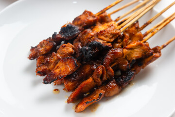 Sate ayam or Satay Ayam is Indonesian food and cuisine of seasoned, skewered and grilled chicken with wooden skewers. Perfect for recipe, article, catalogue, commercial, or any cooking content.
