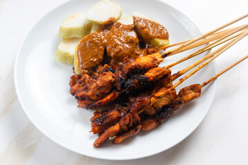 Sate ayam or Satay Ayam is Indonesian food and cuisine of seasoned, skewered and grilled chicken with wooden skewers. Perfect for recipe, article, catalogue, commercial, or any cooking content.
