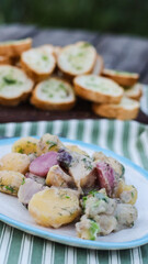 boiled potato salad with sour cream on the table in a plate