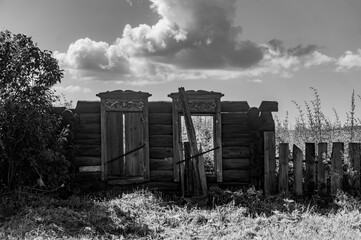 Old wooden gate on the field. Black and white photo. Copy space.