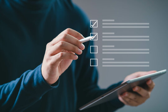 Person using a digital tablet to check items on a virtual checklist. Concept of productivity and task management.