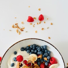 Bowl with Berry, Banana, Yogurt and Granola for Breakfast
