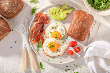 Delicious and crisp breakfast with fried eggs, buns and chive.