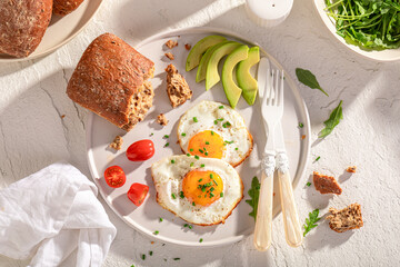 Healthy and homemade breakfast with fried eggs and buns.