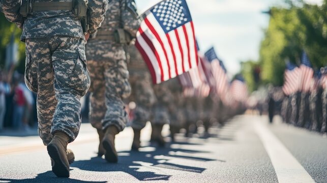Veterans marching in a parade with American flags, representing unity and pride for Veterans Day and Memorial Day.