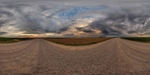 hdri 360 panorama on gravel road among fields in spring nasty evening before sunset in...
