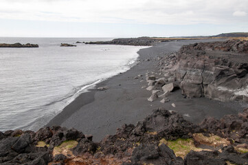 Snaefellsnes Peninsula Iceland, view along a black sand beach from Malarrif lighthouse