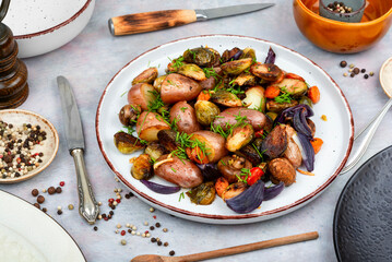 Roasted vegetable medley including potatoes brussels sprout.