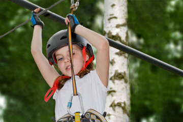 adventure climbing high wire park - people on course in mountain helmet and safety equipment. High quality photo. High quality photo