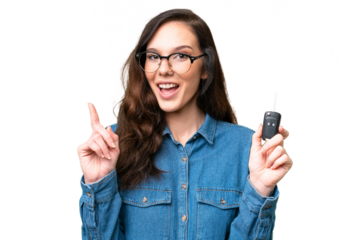 Young caucasian woman holding car keys over isolated background pointing up a great idea