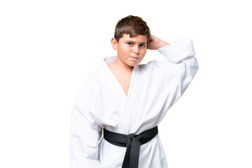 Little caucasian kid doing karate over isolated chroma key background having doubts