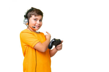 Little caucasian kid playing with a video game controller over isolated chroma key background pointing back
