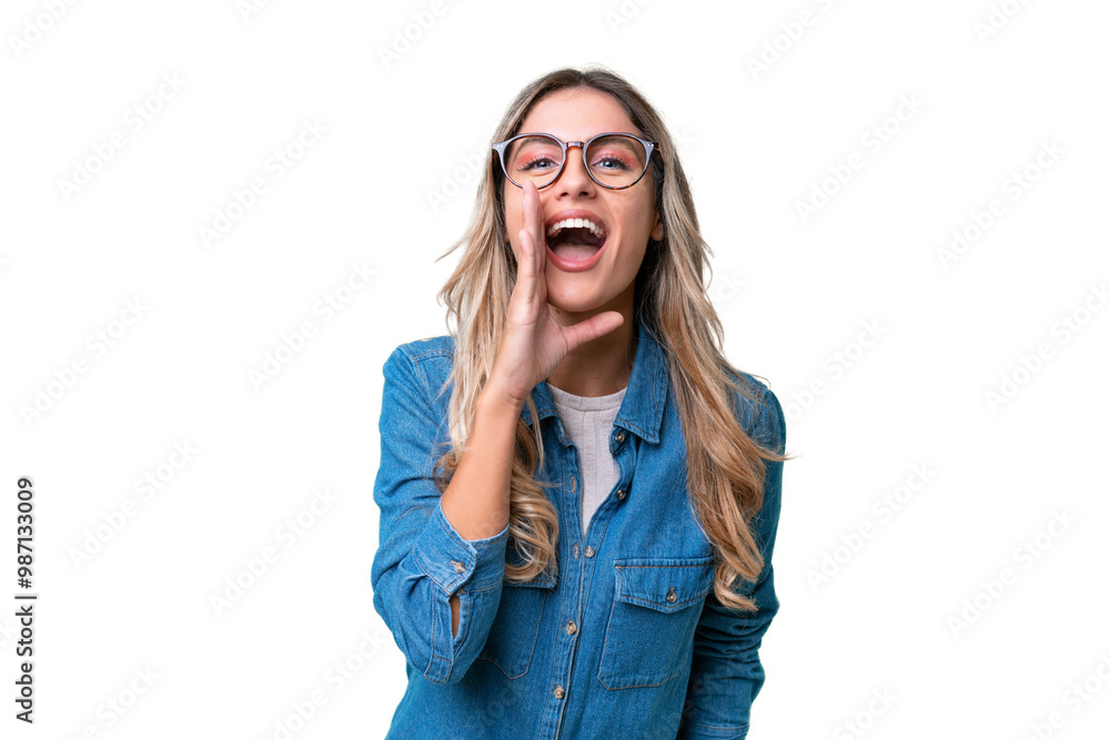 Wall mural Young Uruguayan woman over isolated background shouting with mouth wide open