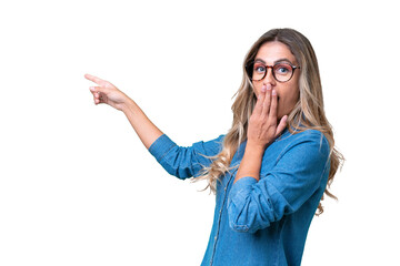 Young Uruguayan woman over isolated background with surprise expression while pointing side