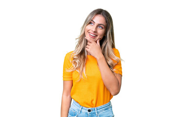 Young Uruguayan woman over isolated background looking to the side and smiling