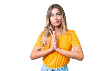 Young Uruguayan woman over isolated background scheming something