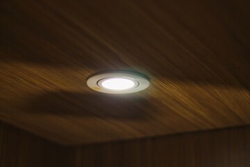 Beautiful light on wooden wall in dim room
