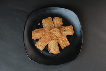 crispy flour fried tempeh which is served on a plate.