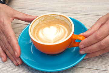 a cup of cappuccino is on the table
