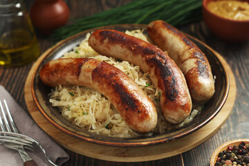 A bowl with Bratwurst and Sauerkraut as side dish - traditional German food