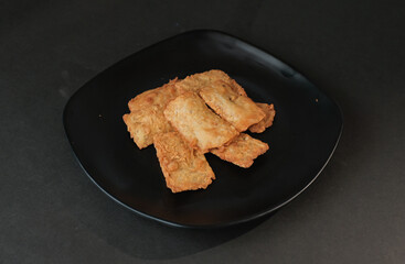 crispy flour fried tempeh which is served on a plate.