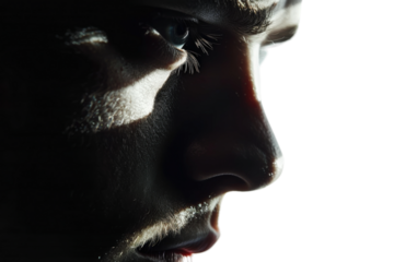 A man with a dark face and a shadow on his face