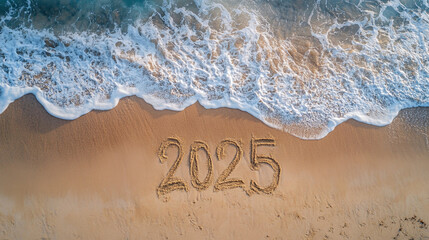 Fototapeta premium 2025 written on empty beach near sea wave symbolizing arrival of new year 2025