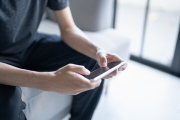 Man playing game on mobile phone. gamer boy playing video games holding Smartphone working mobile devices. cell telephone technology e-commerce concept