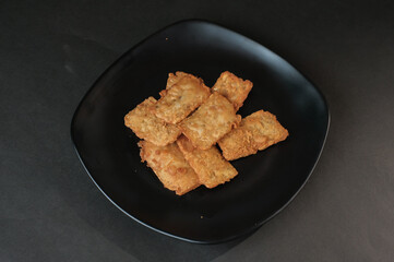 crispy flour fried tempeh which is served on a plate.