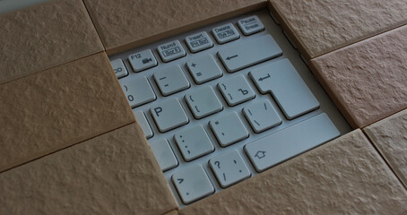 The command buttons and enter key in a hole of solid brickwork. Computers security illustration concept image 
