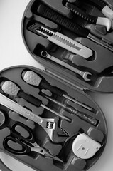 Black and white image of opened plastic toolbox with electrical equipment on white vertical stock photo

