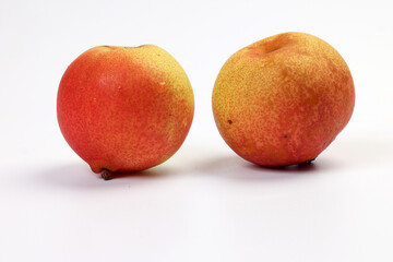 Green yellow red ripe mini pear sweet juicy on white background basket fork