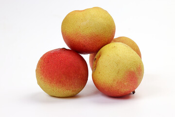 Green yellow red ripe mini pear sweet juicy on white background basket fork