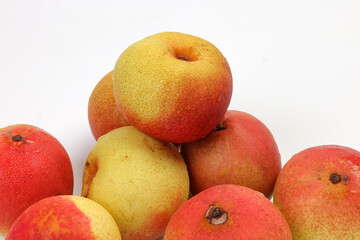 Green yellow red ripe mini pear sweet juicy on white background basket fork