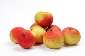 Green yellow red ripe mini pear sweet juicy on white background basket fork