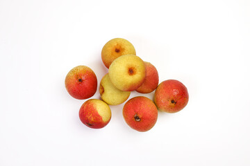 Green yellow red ripe mini pear sweet juicy on white background basket fork