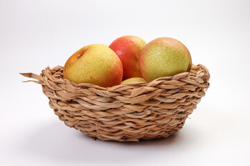 Green yellow red ripe mini pear sweet juicy on white background basket fork