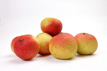 Green yellow red ripe mini pear sweet juicy on white background basket fork