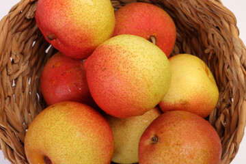 Green yellow red ripe mini pear sweet juicy on white background basket fork