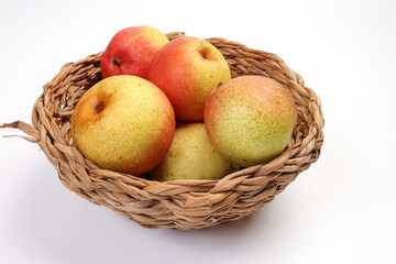 Green yellow red ripe mini pear sweet juicy on white background basket fork