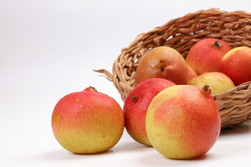Green yellow red ripe mini pear sweet juicy on white background basket fork