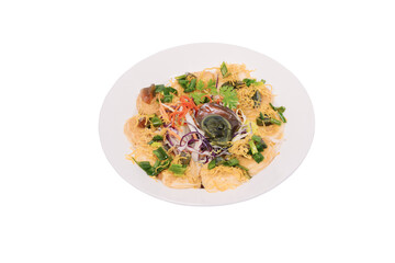 A plate of tofu topped with century eggs, shredded vegetables, and a savory sauce.